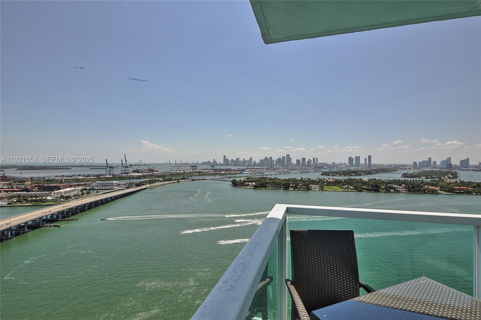 A balcony overlooks a bay, a bridge, and the Miami skyline — 650 West Ave # 2801, Miami Beach FL 33139, MIAMI BEACH, FL