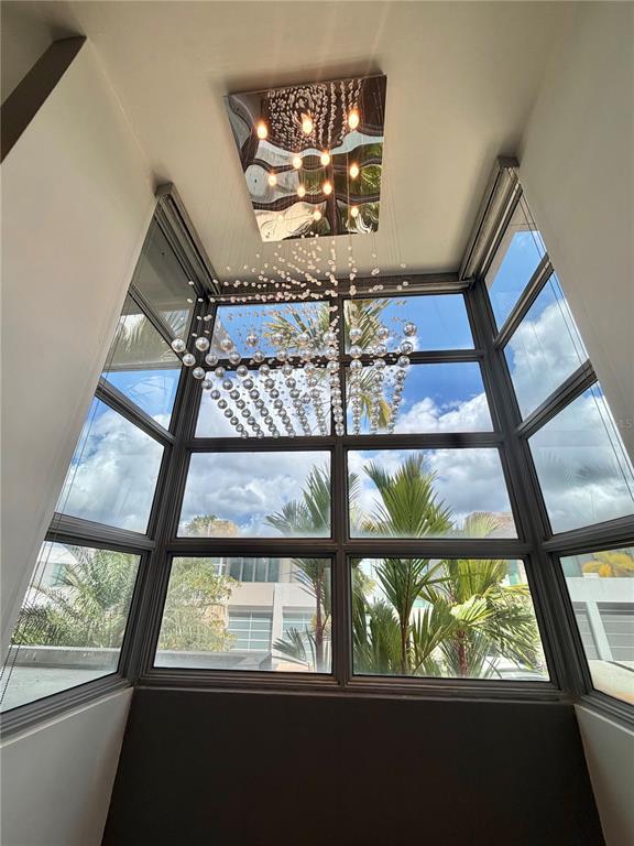A tall windowed alcove features a modern tiered crystal chandelier hanging from the ceiling — 24 CALLE 3 SENDEROS DE MONTEHIEDRA, SAN JUAN, PR