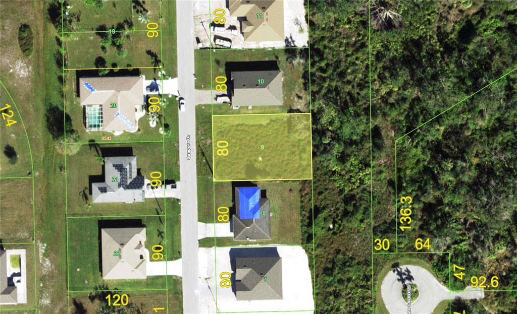 This is an aerial map showing a vacant residential lot highlighted in yellow — 27277 GUAPORE DRIVE, PUNTA GORDA, FL