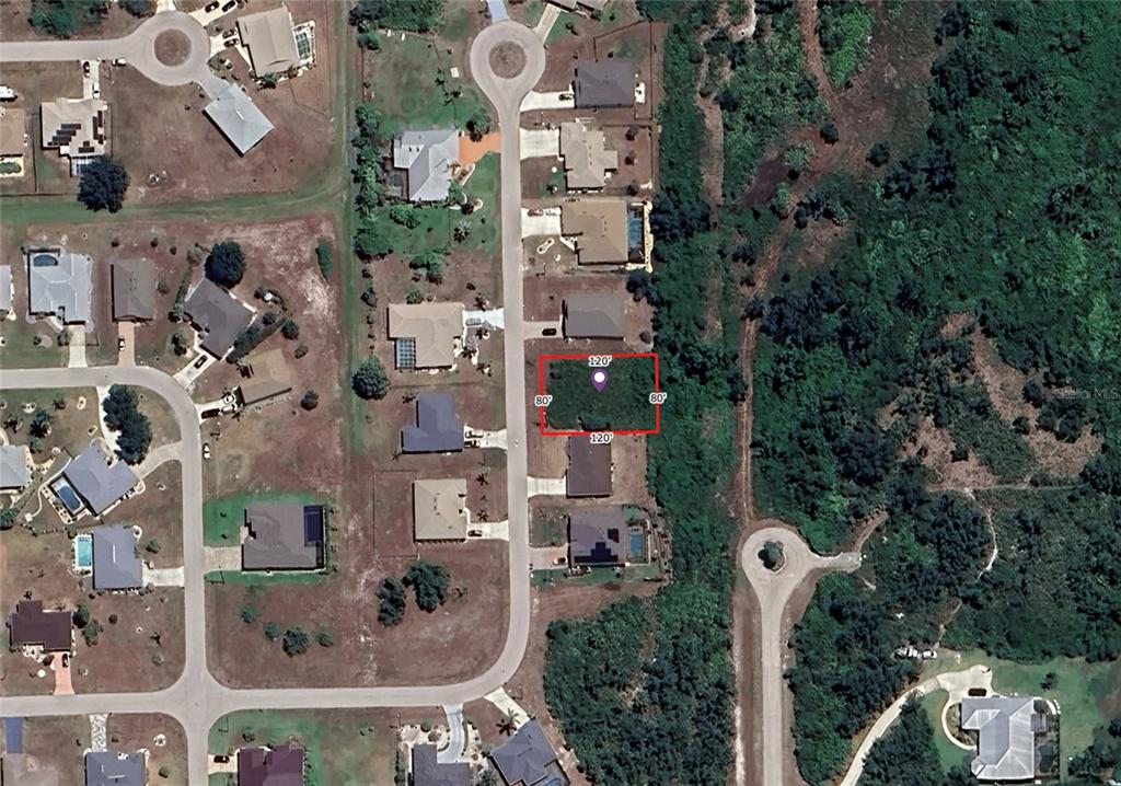 This is an aerial map showing a vacant residential lot outlined in red — 27277 GUAPORE DRIVE, PUNTA GORDA, FL