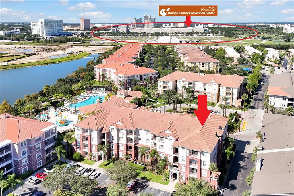 An aerial view shows a multi-story apartment complex with a pool near a convention center — 4862 CAYVIEW AVENUE UNIT 30809, ORLANDO, FL