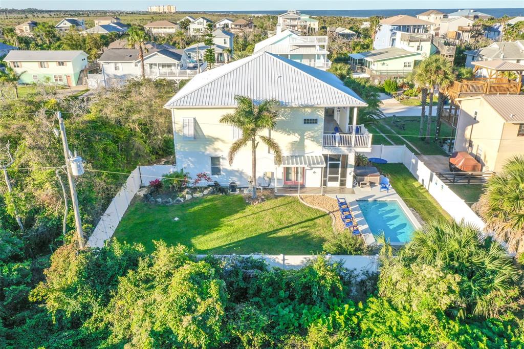 An aerial view of a two-story house with a backyard pool and palm tree — 42 MOODY DRIVE, PALM COAST, FL