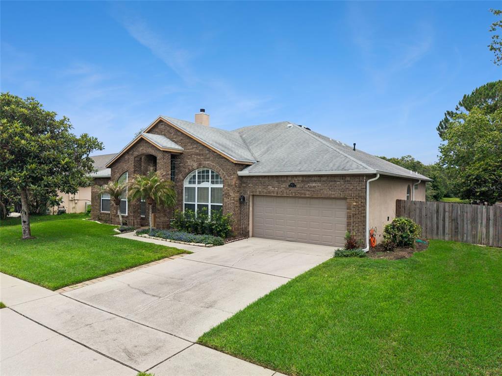 A single-story brick house with a two-car garage and a concrete driveway — 632 TERRACE COVE WAY, ORLANDO, FL