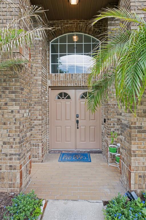 A brick home entrance features double doors, an arched window, and a blue hello mat — 632 TERRACE COVE WAY, ORLANDO, FL