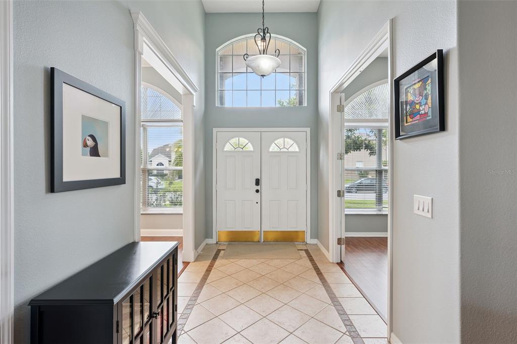 A bright foyer features tile flooring, a double front door, and a high arched window — 632 TERRACE COVE WAY, ORLANDO, FL