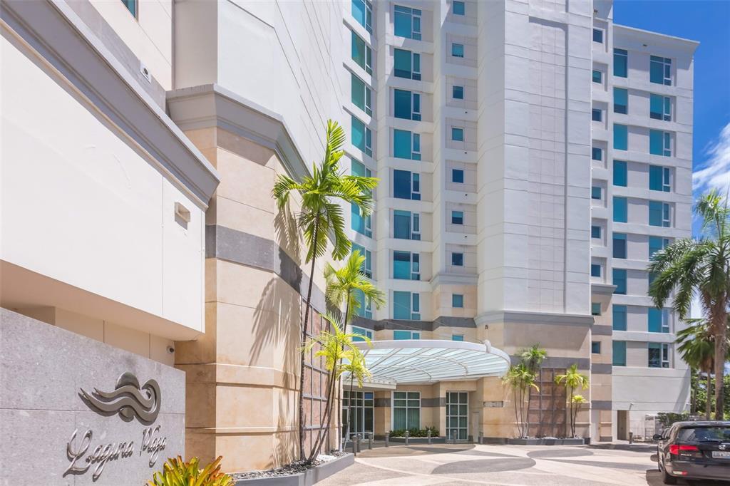 The exterior of a multi-story building with a circular glass canopy and palm trees — 5 MUNOZ RIVERA AVENUE UNIT 504, SAN JUAN, PR