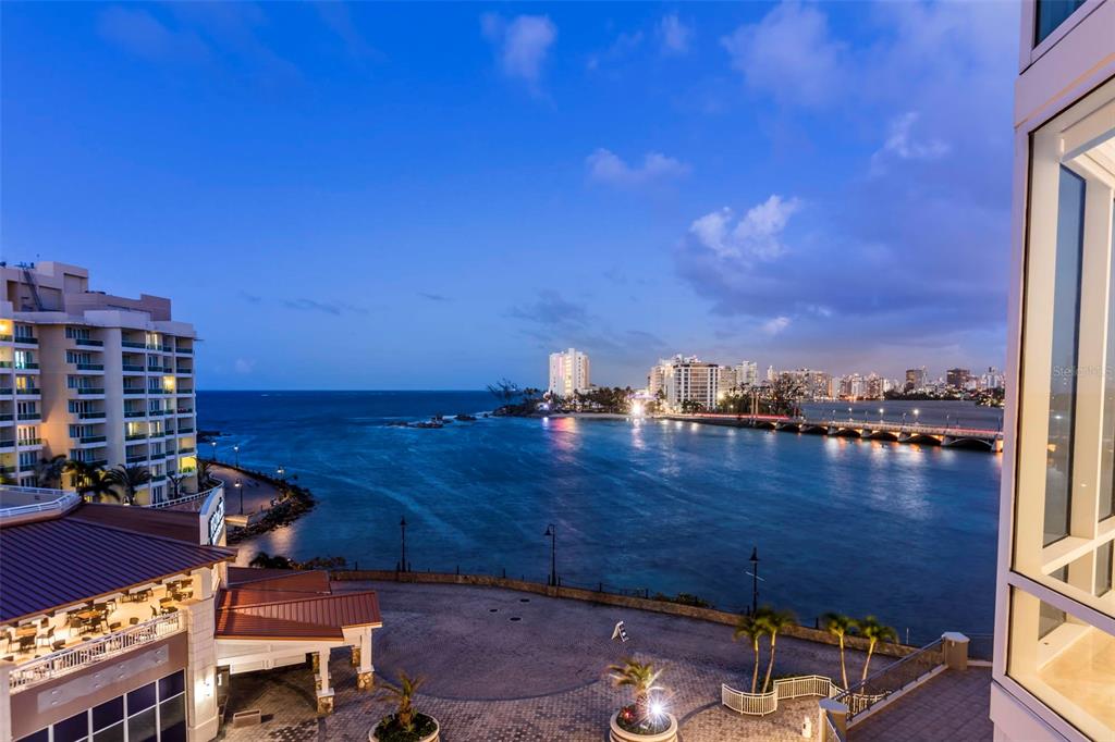 An elevated view of a coastal city skyline, a bridge, and the ocean at dusk — 5 MUNOZ RIVERA AVENUE UNIT 504, SAN JUAN, PR