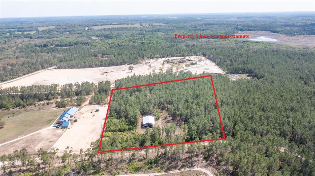An aerial view shows a rectangular property with a house surrounded by dense forest — 5276 ORGANIC. (POLE BARN) ROAD, MELROSE, FL