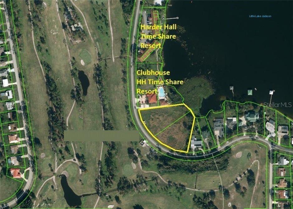 This aerial map shows a vacant lot outlined in yellow next to a resort — 136+142 LAKE DRIVE BOULEVARD, SEBRING, FL