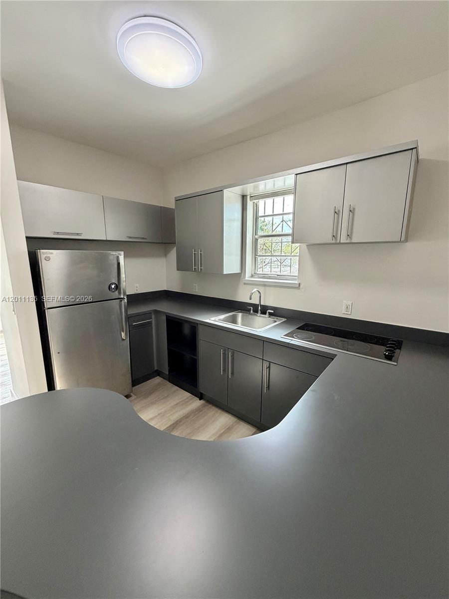 A kitchen features gray cabinets, stainless steel appliances, and a dark countertop — 173 NW 36th St # 2, Miami FL 33127, MIAMI, FL