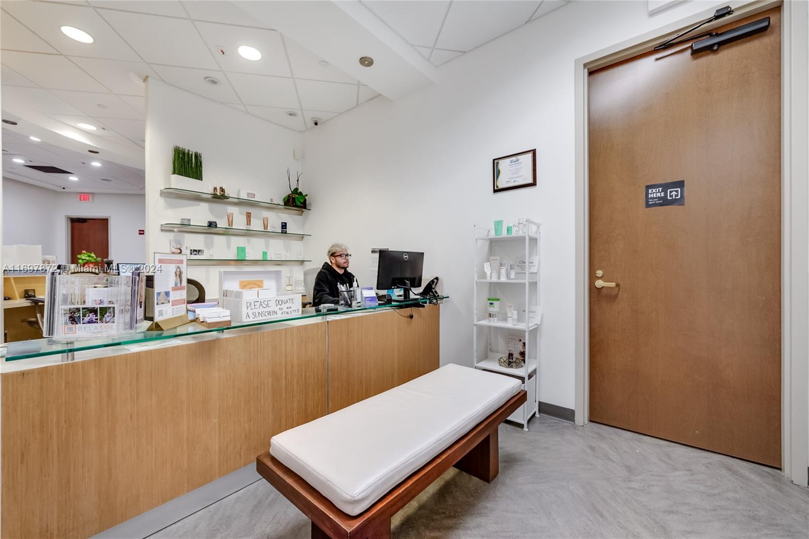 A reception area features a wooden desk, a white bench, and a closed door — 6705 Red Rd # 518, Coral Gables FL 33143, CORAL GABLES, FL