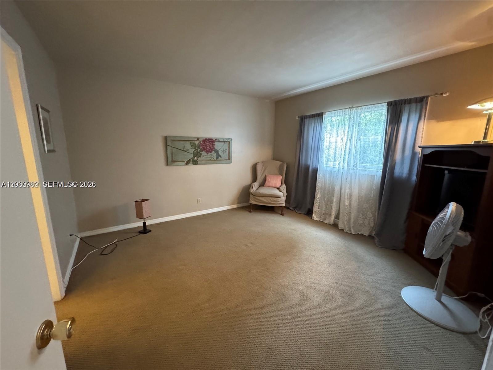 A kitchen features beige cabinets, a stainless steel stove, a white dishwasher, and patterned backsplash — 100 SE 6th Ave # 207, Pompano Beach FL 33060, POMPANO BEACH, FL