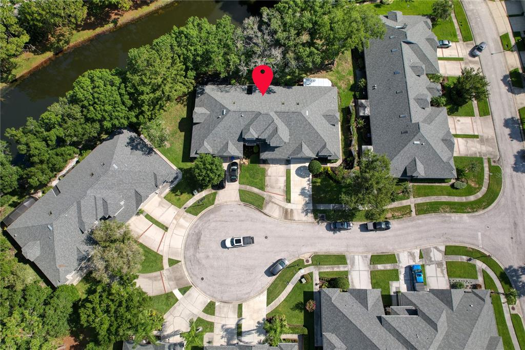 An aerial view shows a residential cul-de-sac with several multi-unit buildings and a nearby canal — 12709 BURMAH COURT, ODESSA, FL