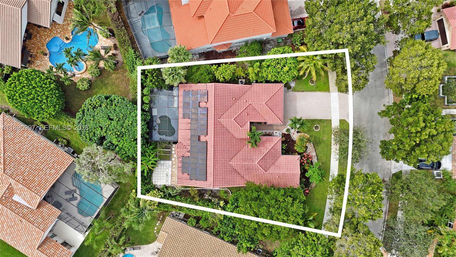 An aerial view shows a house with a red tile roof and solar panels — 523 Stonemont Dr, Weston FL 33326, WESTON, FL