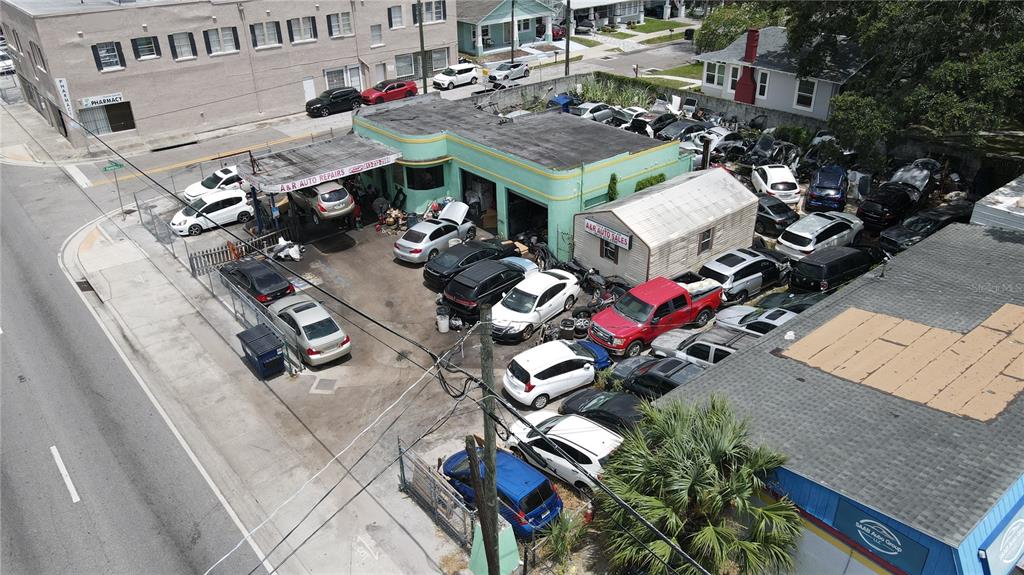 An aerial view shows an auto repair shop and car sales lot with many vehicles — 7279 N NEBRASKA AVENUE, TAMPA, FL