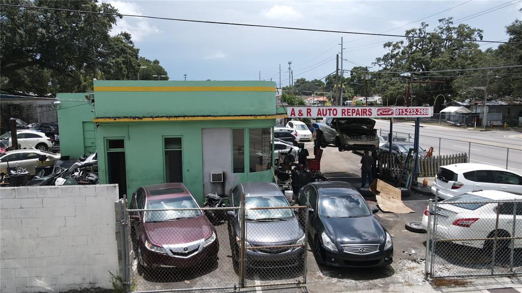 An exterior view of an auto repair shop with several cars parked in the lot — 7279 N NEBRASKA AVENUE, TAMPA, FL