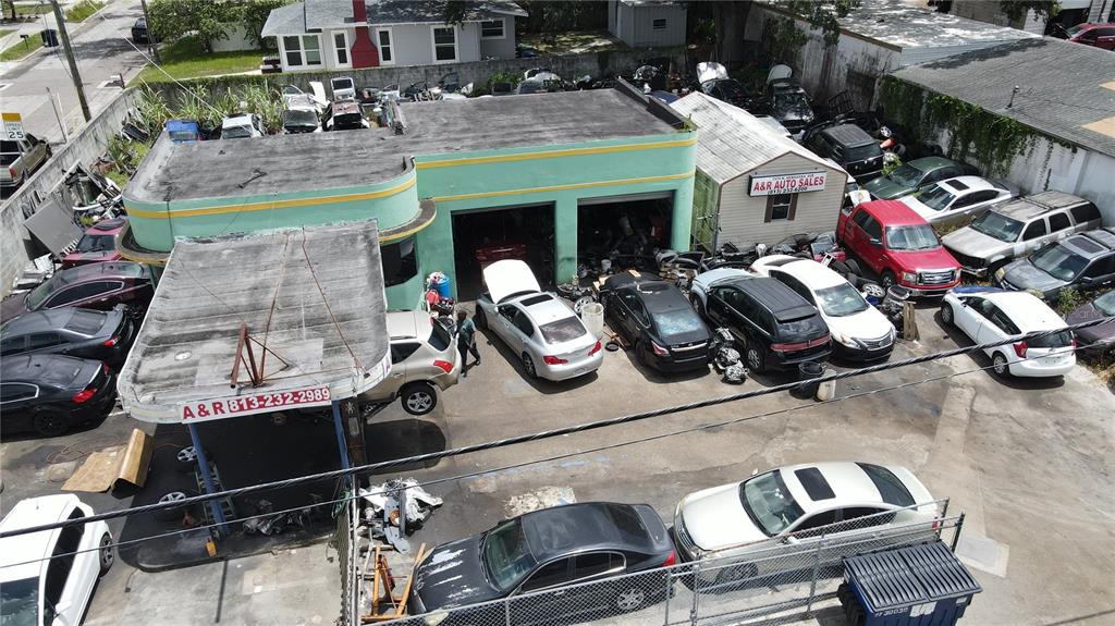 An aerial view shows an auto repair shop with multiple cars parked on the lot — 7279 N NEBRASKA AVENUE, TAMPA, FL