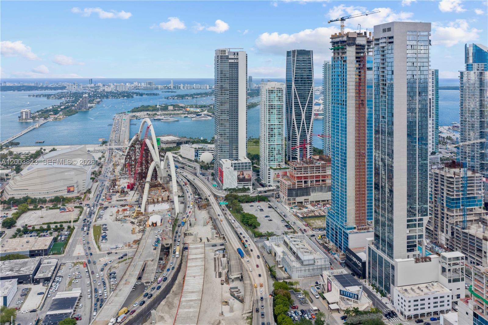 An aerial view of the Miami skyline featuring high-rise buildings and the Signature Bridge construction — 20 NE 11th St # 4602, Miami FL 33132, MIAMI, FL