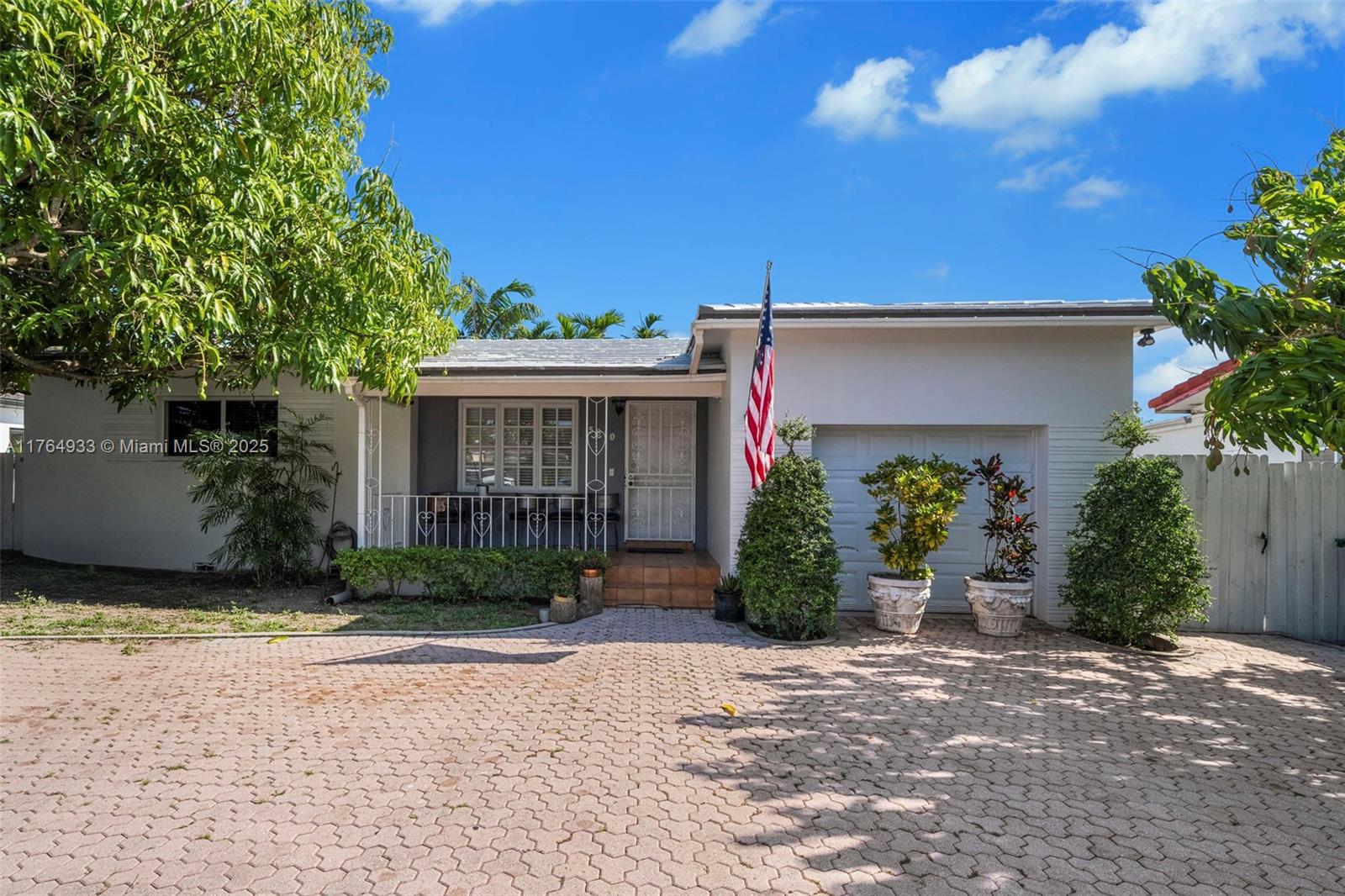 A single-story house features a white brick exterior, a paved driveway, and a front porch — 5810 SW 22nd St, Miami FL 33155, MIAMI, FL