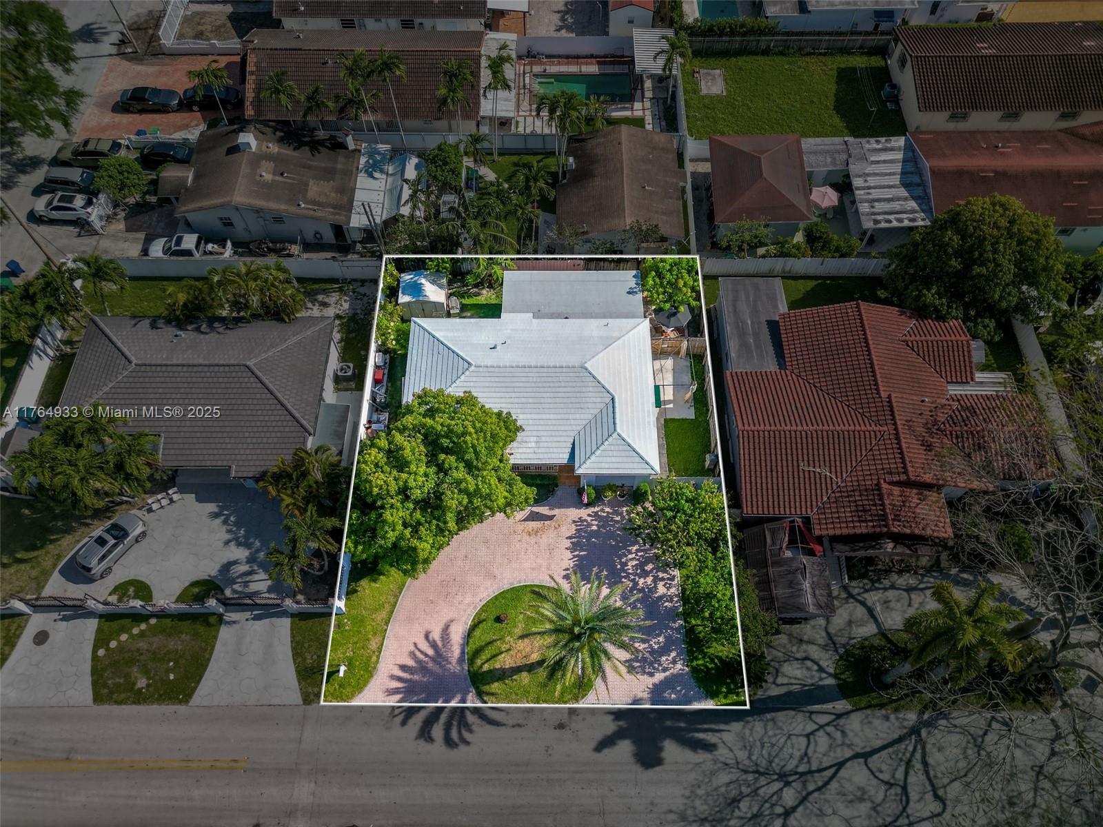 An aerial view shows a house with a light-colored roof, circular driveway, and landscaping — 5810 SW 22nd St, Miami FL 33155, MIAMI, FL