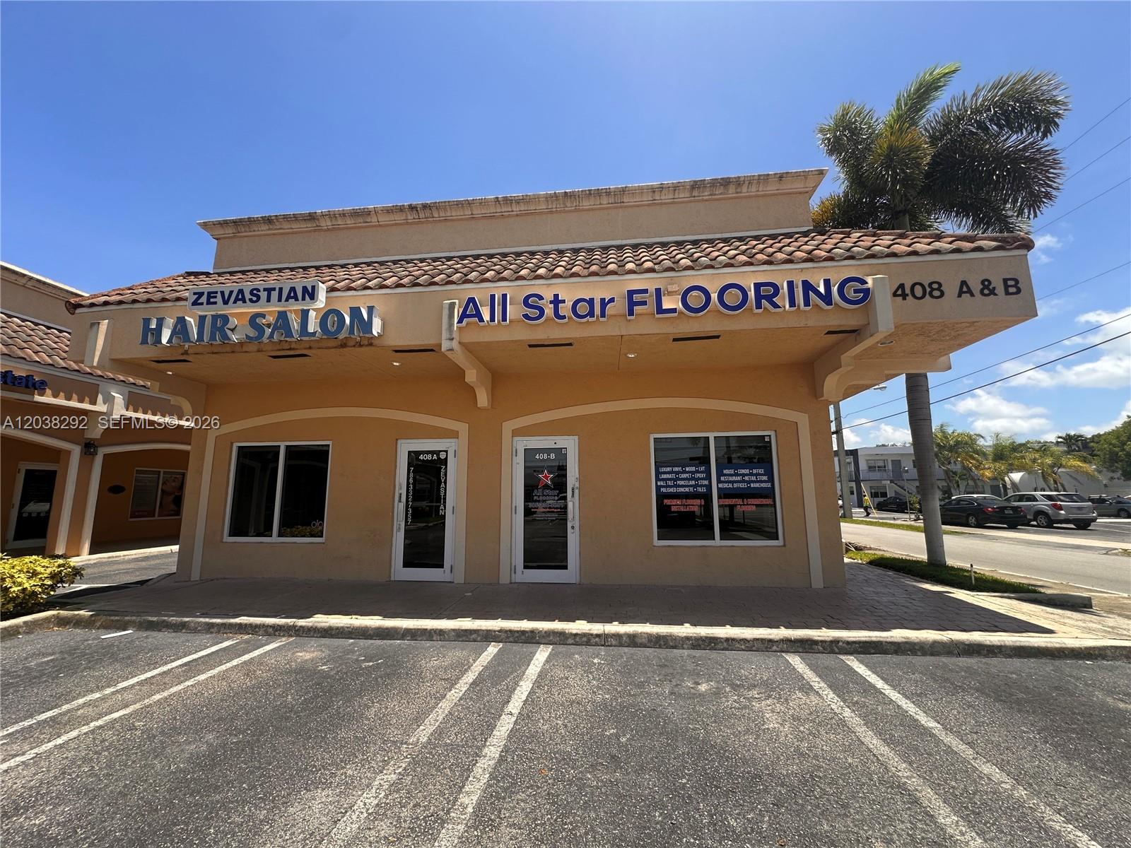 The exterior of a commercial building features a hair salon and a flooring store — 400 E Hallandale Beach Blvd, Hallandale Beach FL 33009, HALLANDALE BEACH, FL