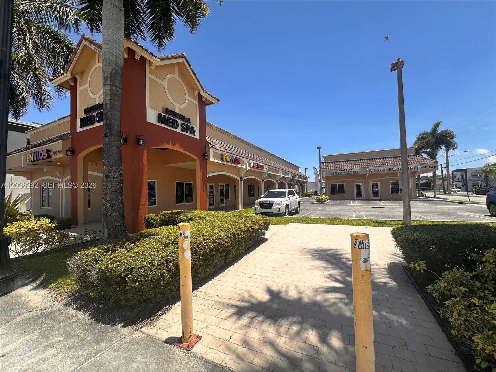 A strip mall exterior features a tan building with a Med Spa and parking lot — 400 E Hallandale Beach Blvd, Hallandale Beach FL 33009, HALLANDALE BEACH, FL