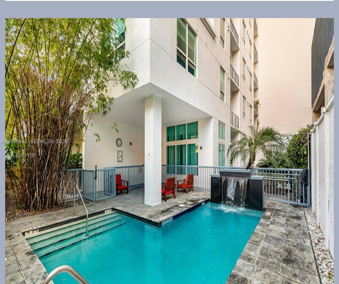 A small rectangular swimming pool with a water feature sits beside a covered patio area — 234 NE 3rd St # 1506, Miami FL 33132, MIAMI, FL