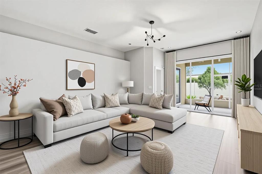 A living room features a sectional sofa, round coffee table, and sliding doors to a patio — 427 FERN GULLEY DRIVE, SEFFNER, FL