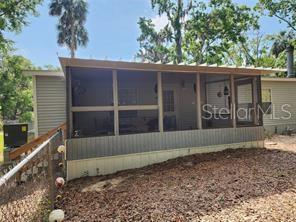A screened-in porch with a metal roof is attached to the side of a house — 5550 S CORAL BELLS AVENUE, HOMOSASSA, FL
