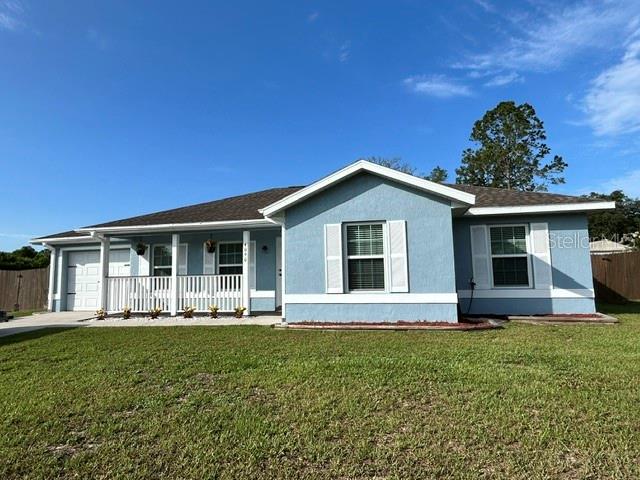 A light blue, single-story house with a front porch and a dark shingled roof — 4090 SW 167TH STREET, OCALA, FL