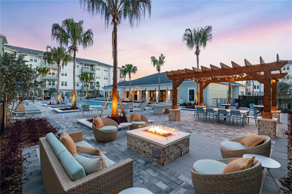 An outdoor patio area features a fire pit, lounge seating, a pergola, and a swimming pool — 14370 FL-64 ROAD UNIT C1.1, BRADENTON, FL