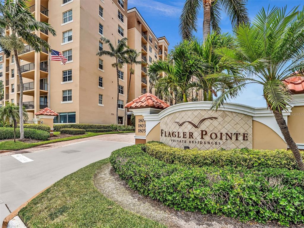 The exterior entrance sign for Flagler Pointe Private Residences stands before a multi-story apartment building — 1801 N FLAGLER DRIVE UNIT 416, WEST PALM BEACH, FL