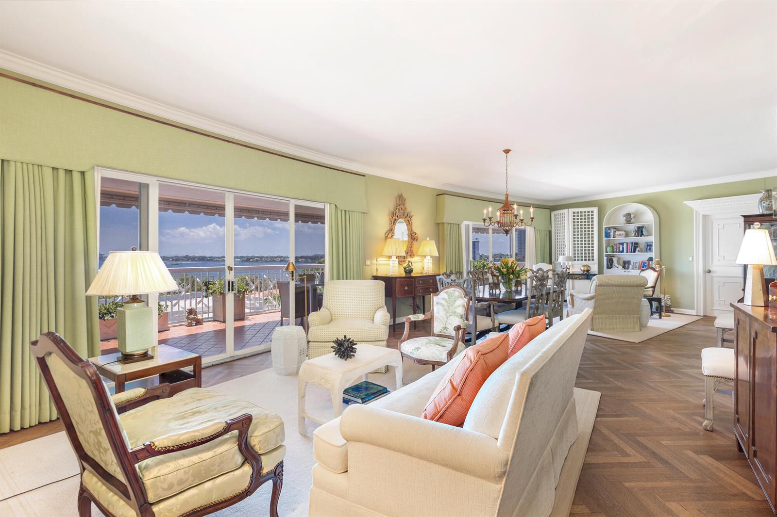 A spacious living and dining room features light green walls, hardwood floors, and a balcony — 389 S Lake Drive, Palm Beach FL 33480, PALM BEACH, FL