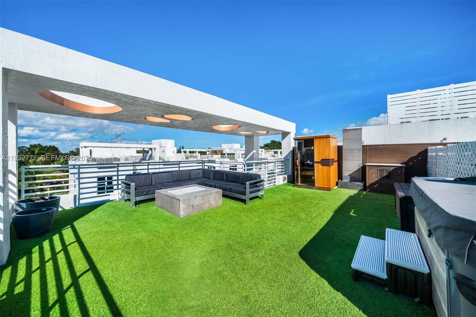 A rooftop terrace features artificial turf, a sectional sofa, a fire pit, and a sauna — 455 NE 39th St # 202, Miami FL 33137, MIAMI, FL