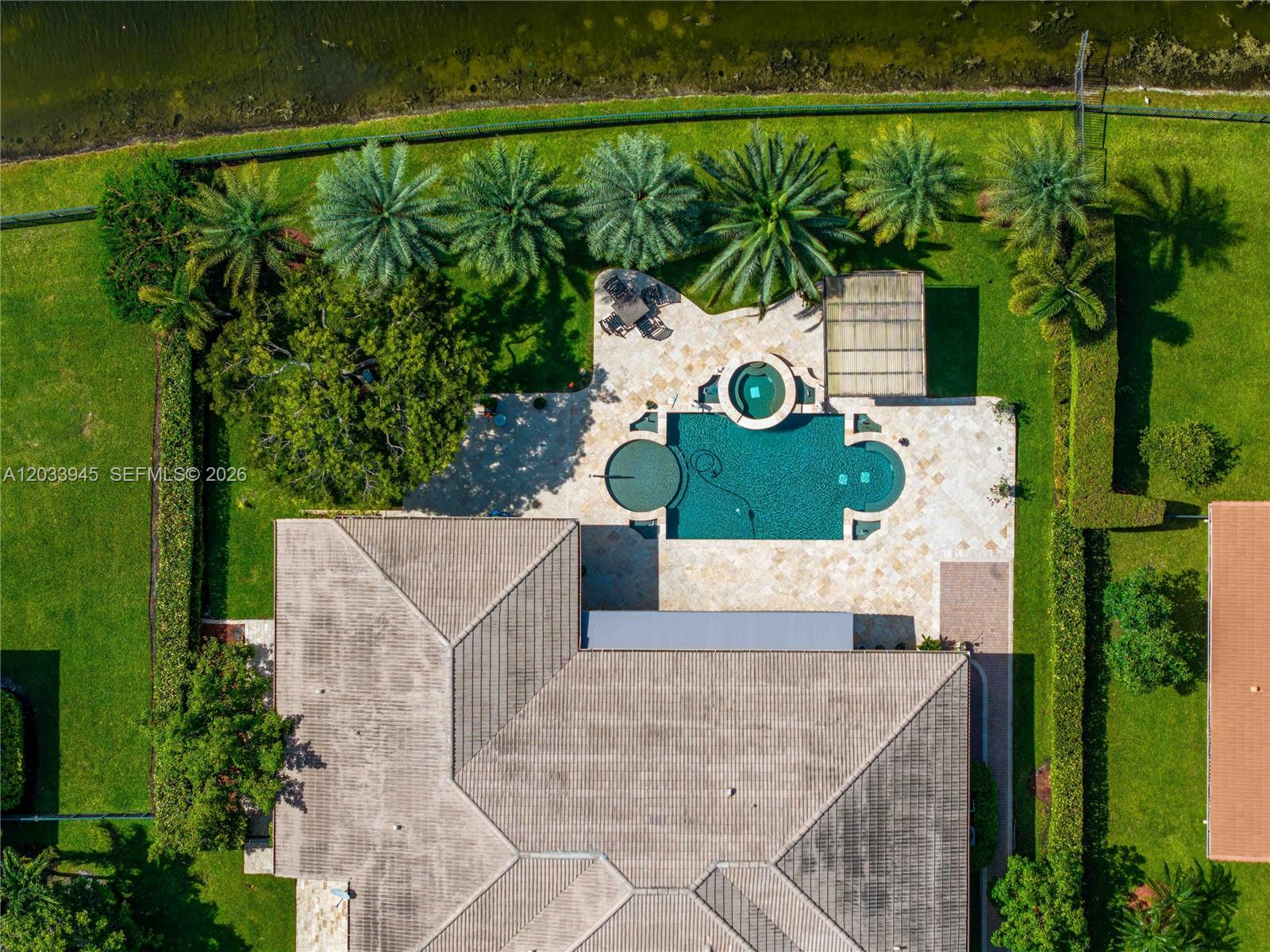 An aerial view shows a house with a swimming pool, spa, and patio in a backyard — 15253 SW 40th St # 0, Davie FL 33331, DAVIE, FL