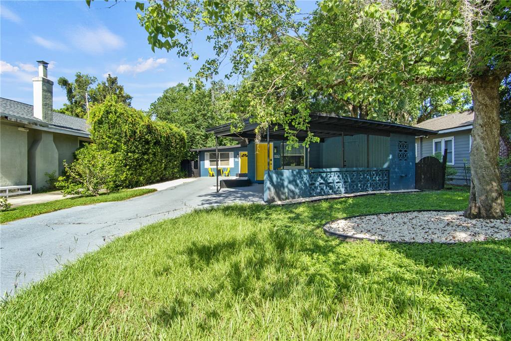 A blue house with a carport, a yellow front door, and a paved driveway — 1612 & 1614 FERRIS AVENUE, ORLANDO, FL