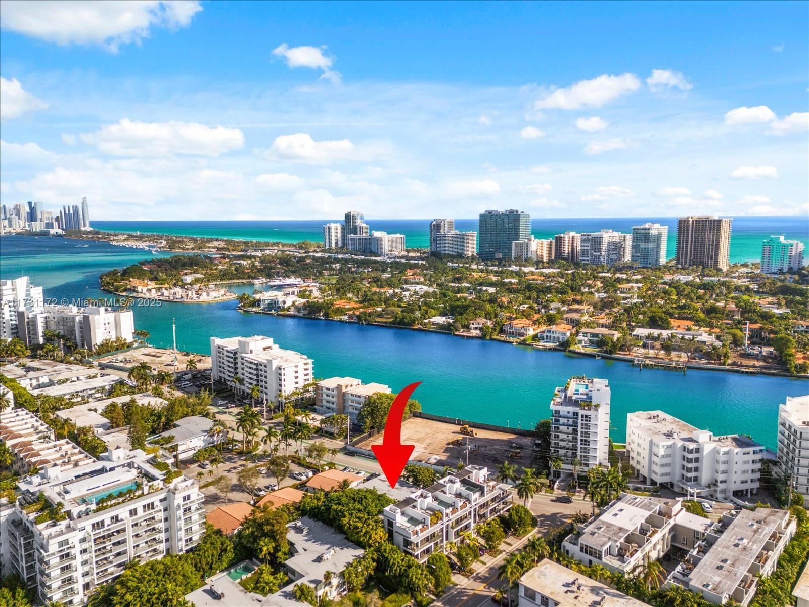 An aerial view shows a multi-story residential building highlighted by a red arrow near water — 9950 E Bay Harbor Dr, Bay Harbor Islands FL 33154, BAY HARBOR ISLANDS, FL