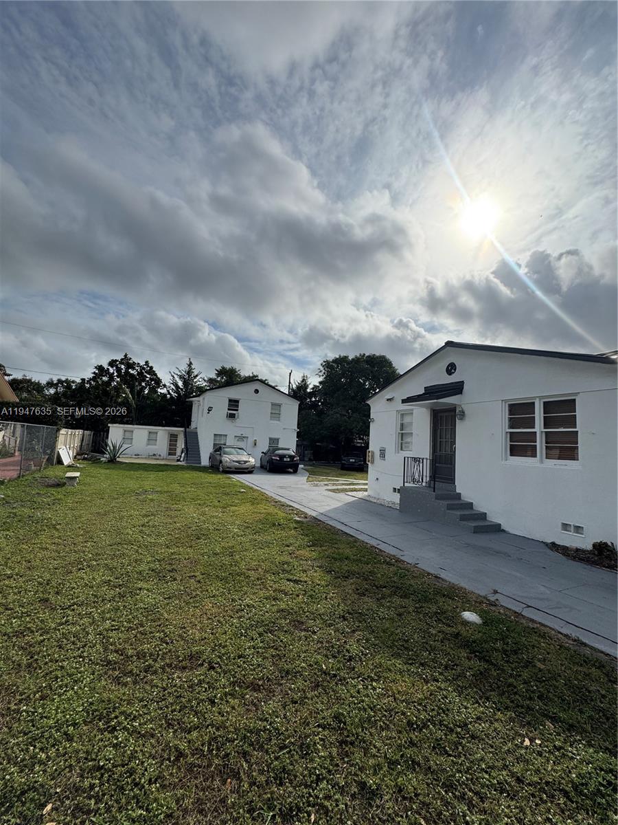 Two white residential buildings stand on a grassy lot with a paved driveway — 921 N 17th Ct # 925, Hollywood FL 33020, HOLLYWOOD, FL
