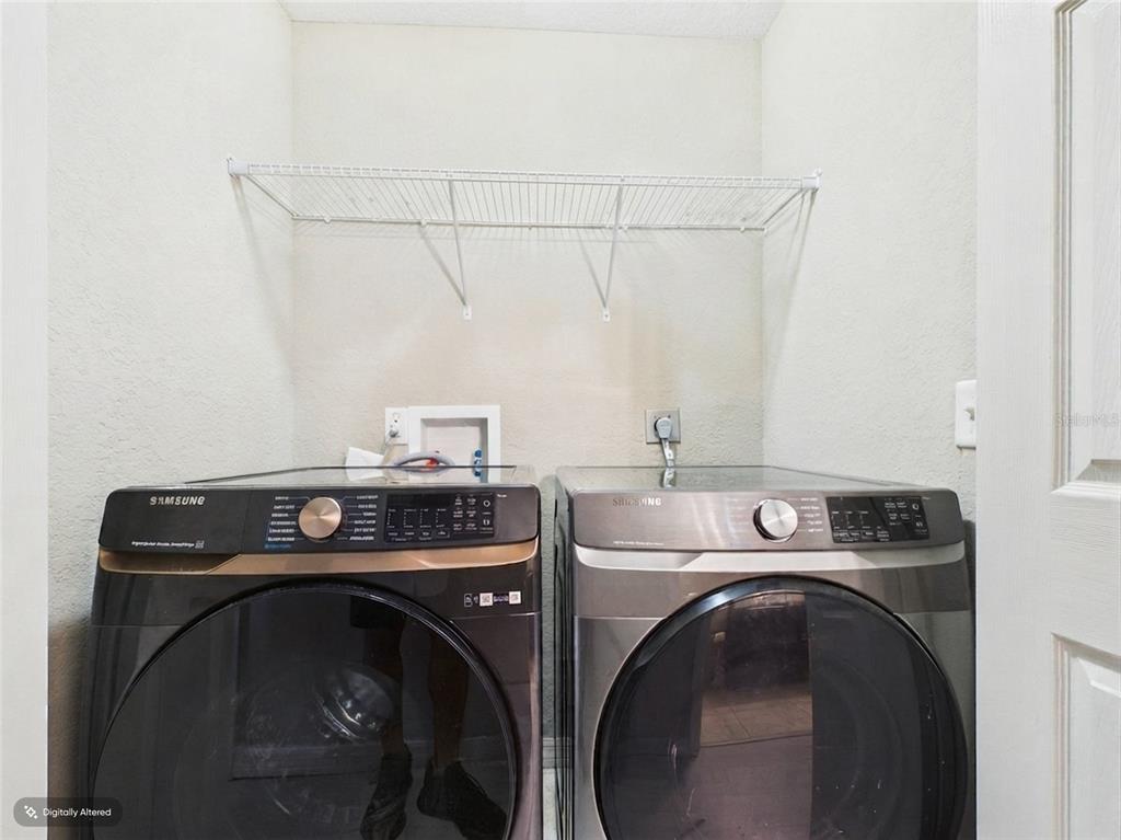 A laundry room features a wire shelf above two Samsung front-load washing machines — 15734 SW 46TH AVENUE ROAD, OCALA, FL