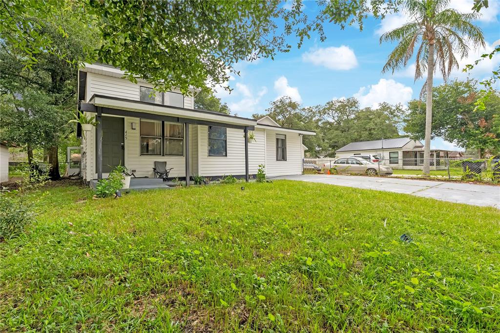 A white, single-story house with a covered front porch and a concrete driveway — 415 S LANCELOT AVENUE, ORLANDO, FL