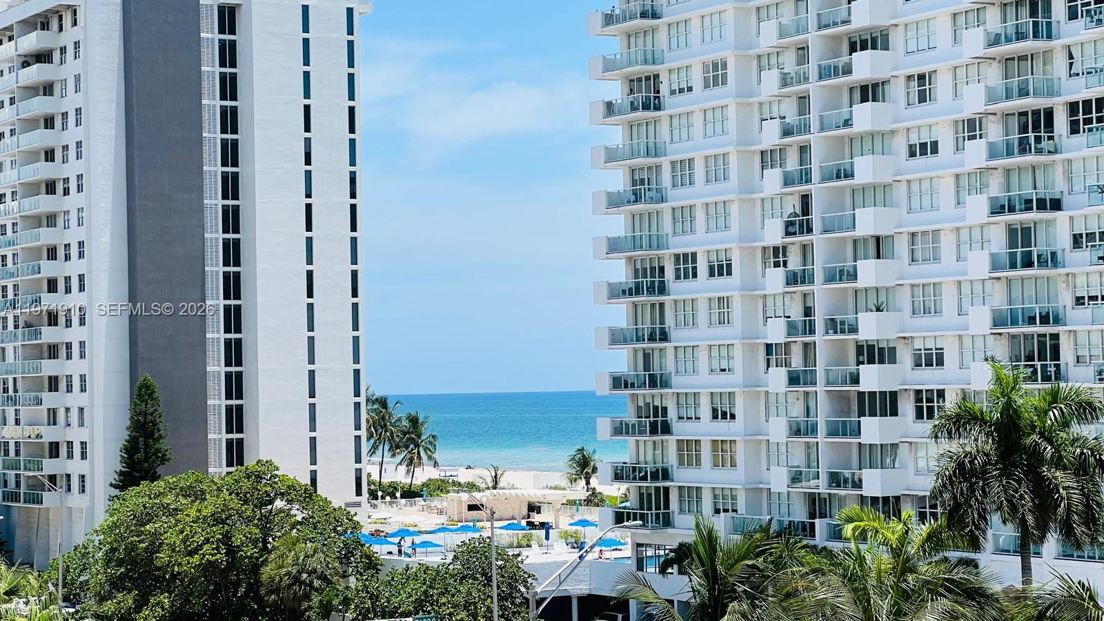 A view of the ocean framed by two tall white residential apartment buildings — 5600 Collins Ave # 7Y, Miami Beach FL 33140, MIAMI BEACH, FL