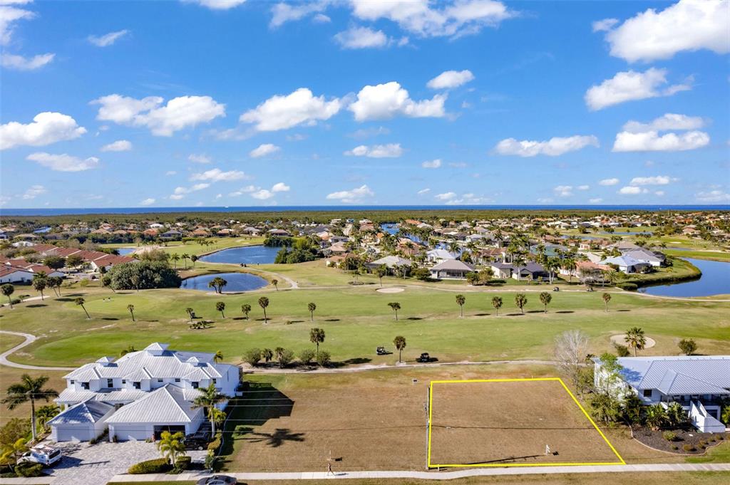 An aerial view shows a vacant residential lot outlined in yellow next to a house — 3639 BAL HARBOR BOULEVARD, PUNTA GORDA, FL