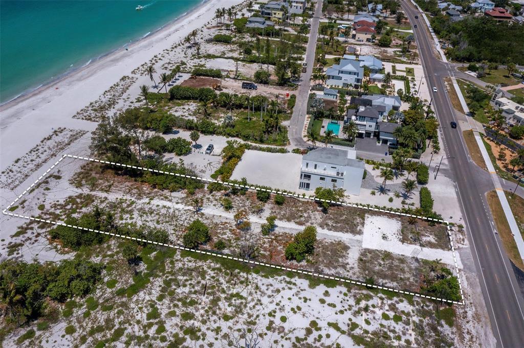 An aerial view shows a vacant, rectangular beachside lot outlined with a dashed white line — 6351 GULF OF MEXICO DRIVE, LONGBOAT KEY, FL