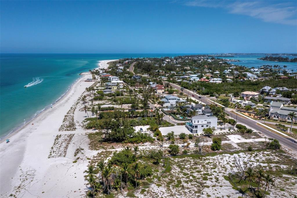 An aerial view shows a white sandy beach along the ocean next to coastal homes — 6351 GULF OF MEXICO DRIVE, LONGBOAT KEY, FL