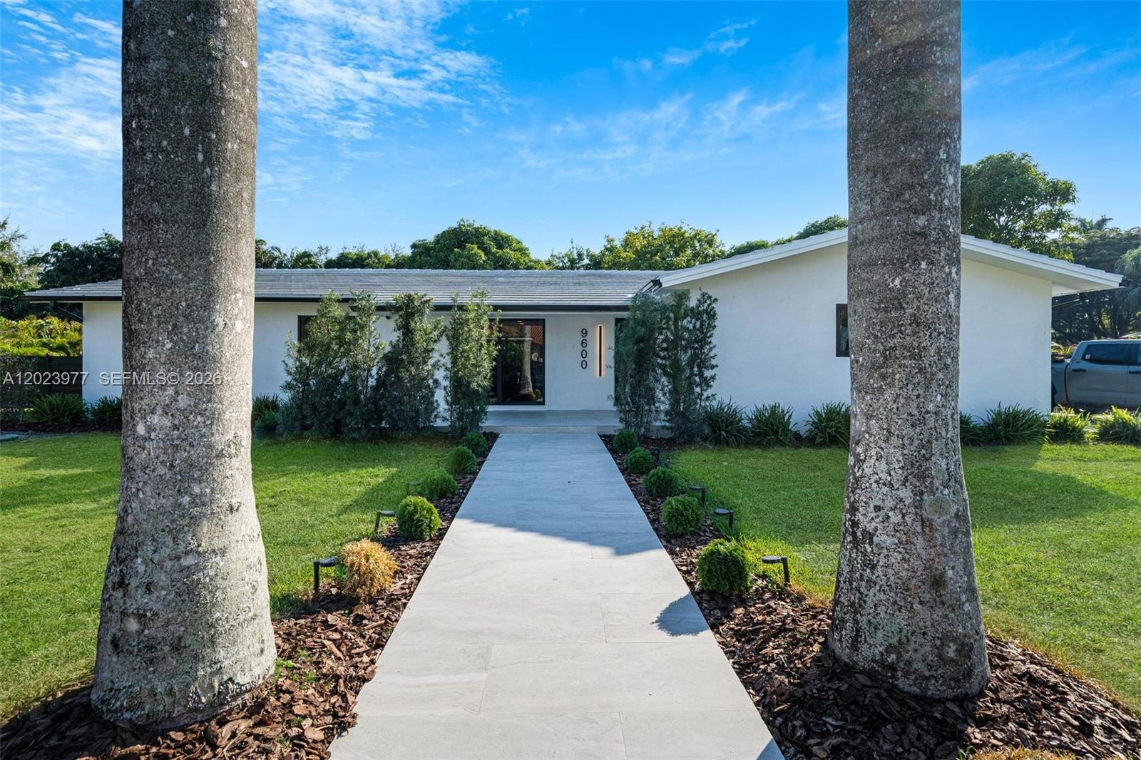 A white single-story house features a paved walkway leading to the front entrance — 9600 SW 147th St, Miami FL 33176, MIAMI, FL