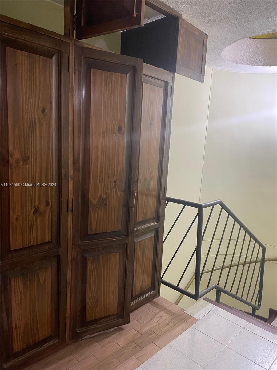 A wooden cabinet stands next to a staircase with a black metal railing — Carrera 22 # 3 02 Buga Los Portales del Rios, FL, FL