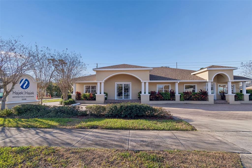 The exterior of a single-story commercial building features a tan facade with arched entryways — 5308 CENTRAL AVENUE, ST PETERSBURG, FL