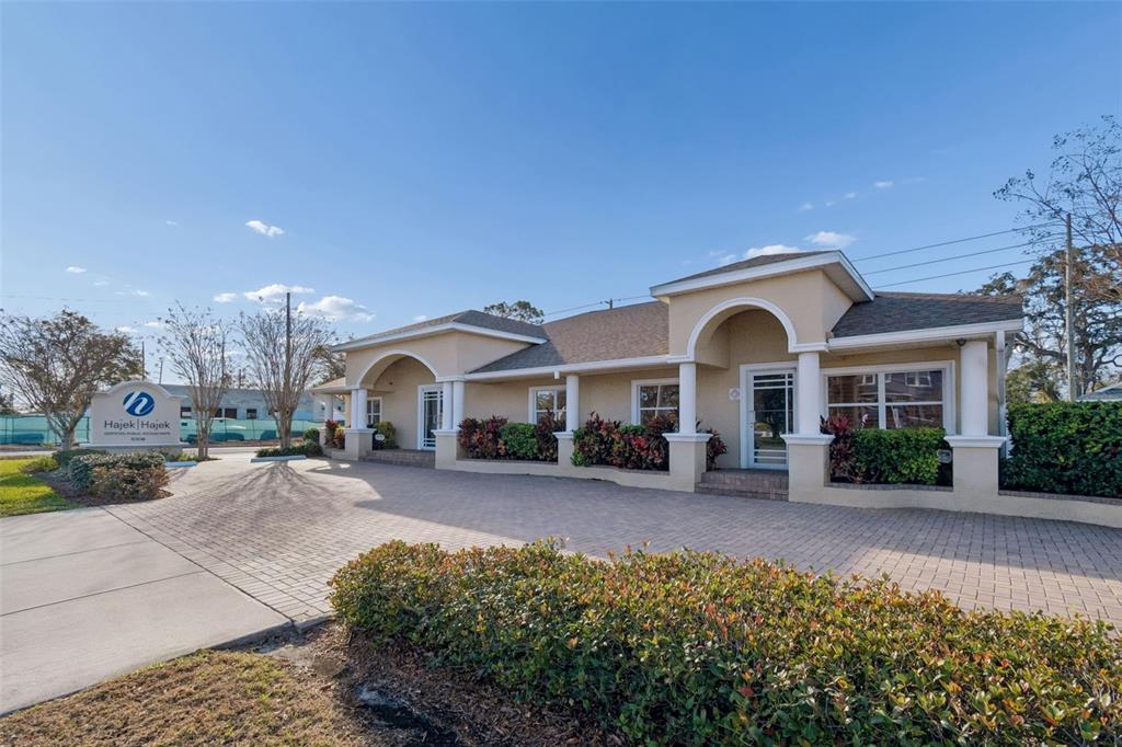 A single-story commercial building with a paved parking lot and a prominent business sign — 5308 CENTRAL AVENUE, ST PETERSBURG, FL