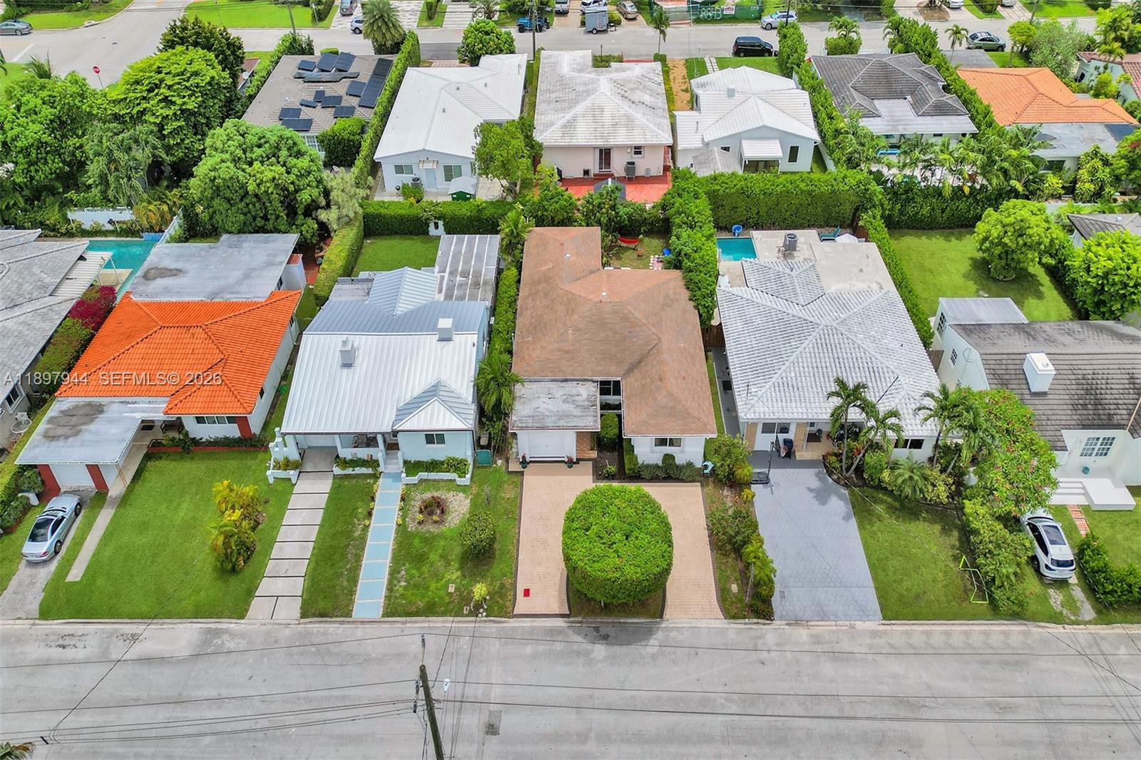 An aerial view shows a row of suburban houses with driveways and green lawns — 8851 Byron Ave, Surfside FL 33154, SURFSIDE, FL