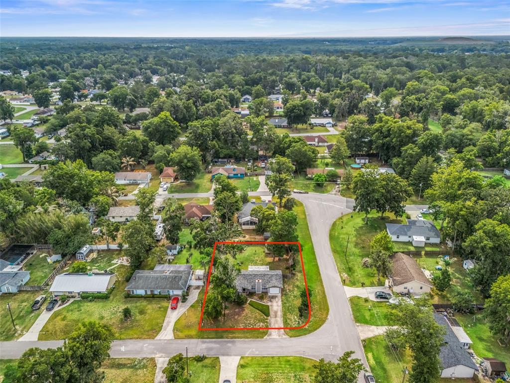 An aerial view shows a single-story house with a red outline on a corner lot — 5073 SE 33RD TERRACE, OCALA, FL